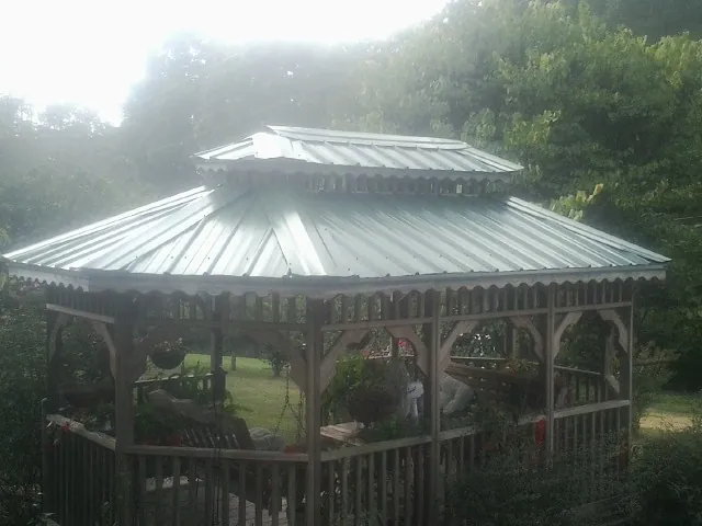 Two tier green metal roof on a garden gazebo in Moundridge